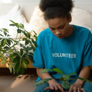 Boy in Blue Crew Neck T-shirt Sitting on Blue Bed