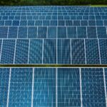 Contemporary installation of solar panels mounted on field in environmental friendly solar power station